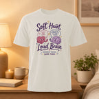 White t-shirt with "Soft Heart, Loud Brain" graphic and text about kindness and facts.