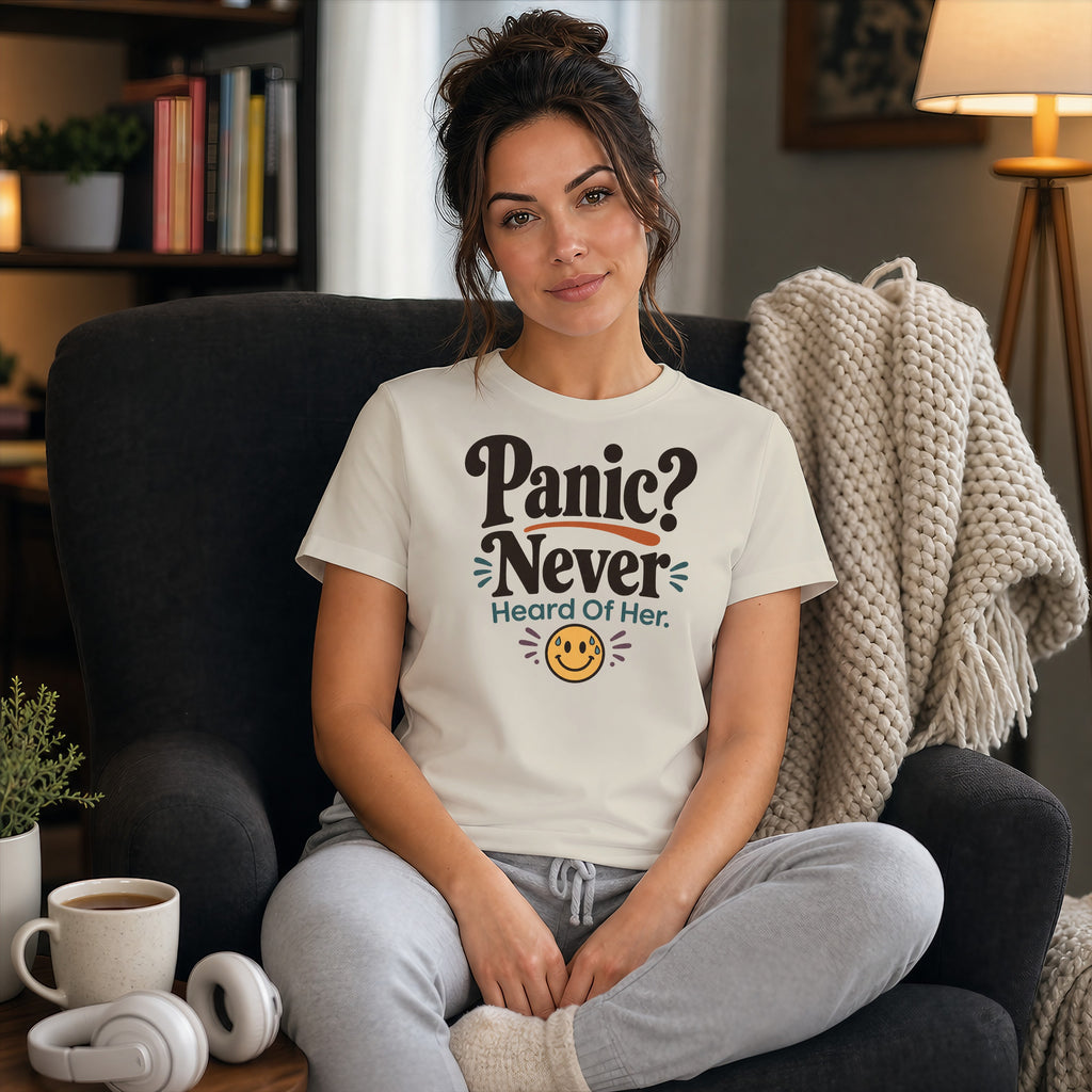 Woman wearing a t-shirt that reads "Panic? Never. Heard of Her." with a smiley face.