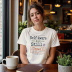 Woman wearing a white t-shirt with "Self-Aware and Still Unwell" text.