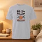 White t-shirt with "I'm Fine. It's Fine. Everything's Fine." and smiling sun graphic.