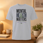 White t-shirt with "MENTAL HEALTH MATTERS" text and green ribbon.