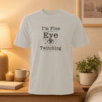 Light gray t-shirt with "I'm Fine But My Eye Is Twitching" text and an eye graphic.