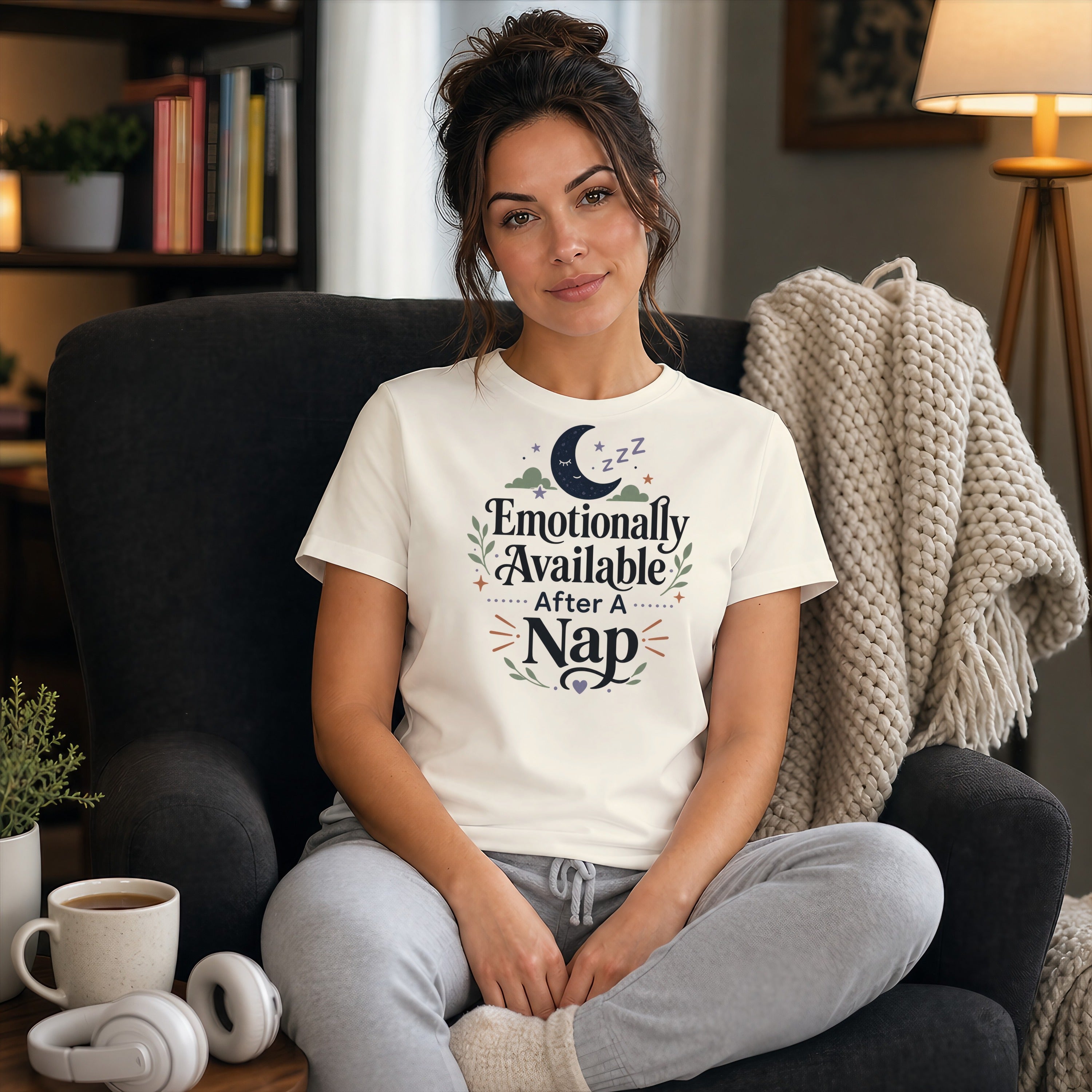 Woman wearing a t-shirt that says "Emotionally Available After A Nap."