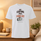 White t-shirt with "My Coping Skill is Leaving Early" graphic.