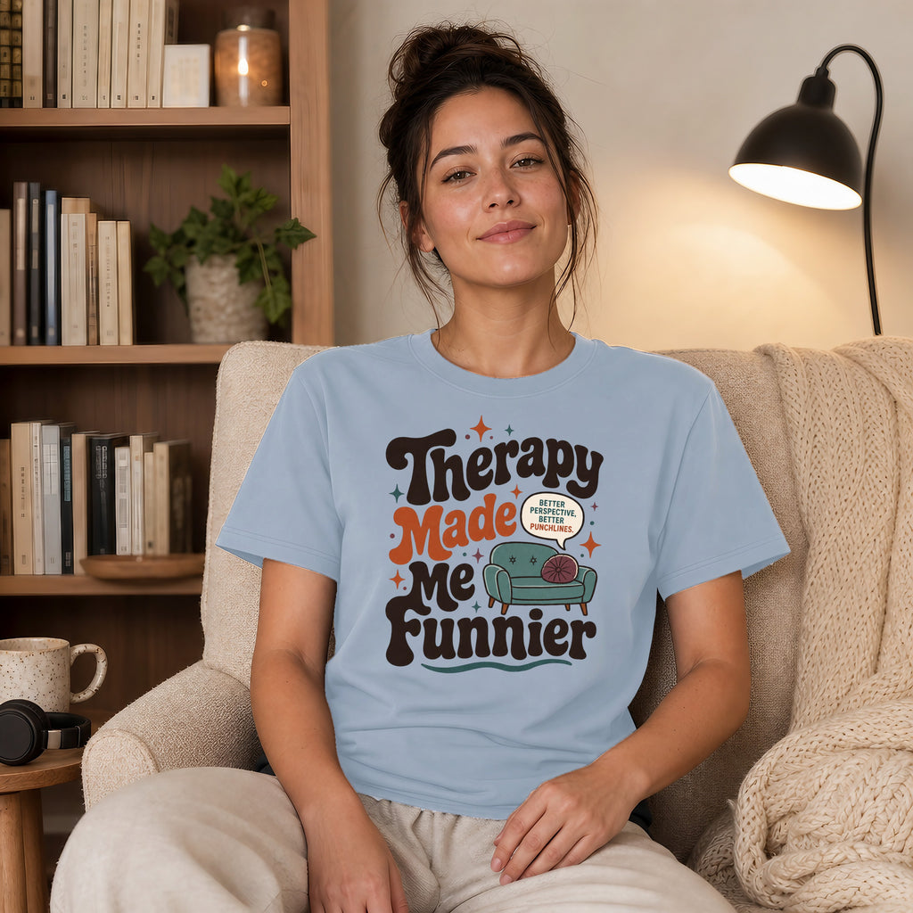 Light blue t-shirt with "Therapy Made Me Funnier" and couch graphic.