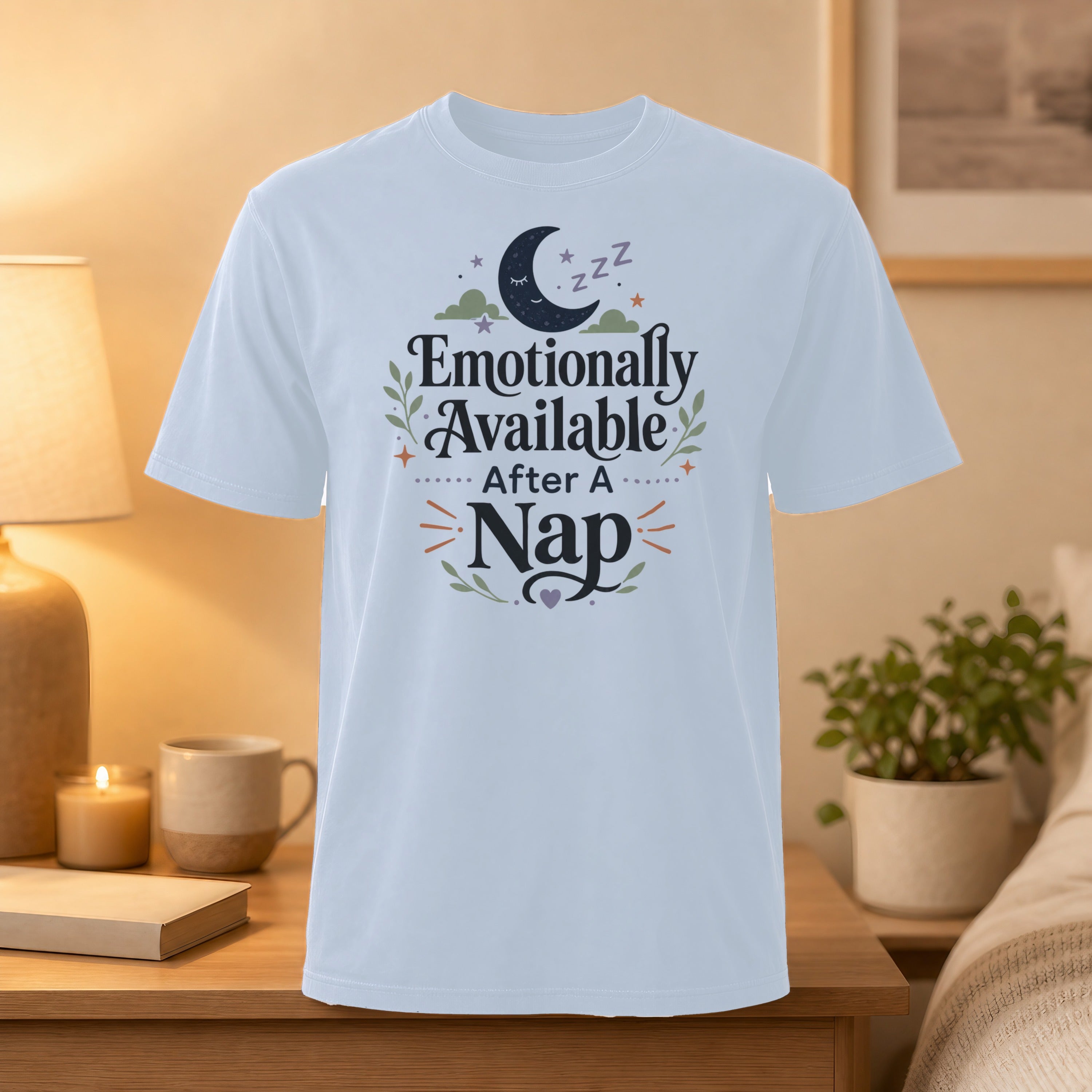 White t-shirt with "Emotionally Available After A Nap" text and moon graphic.