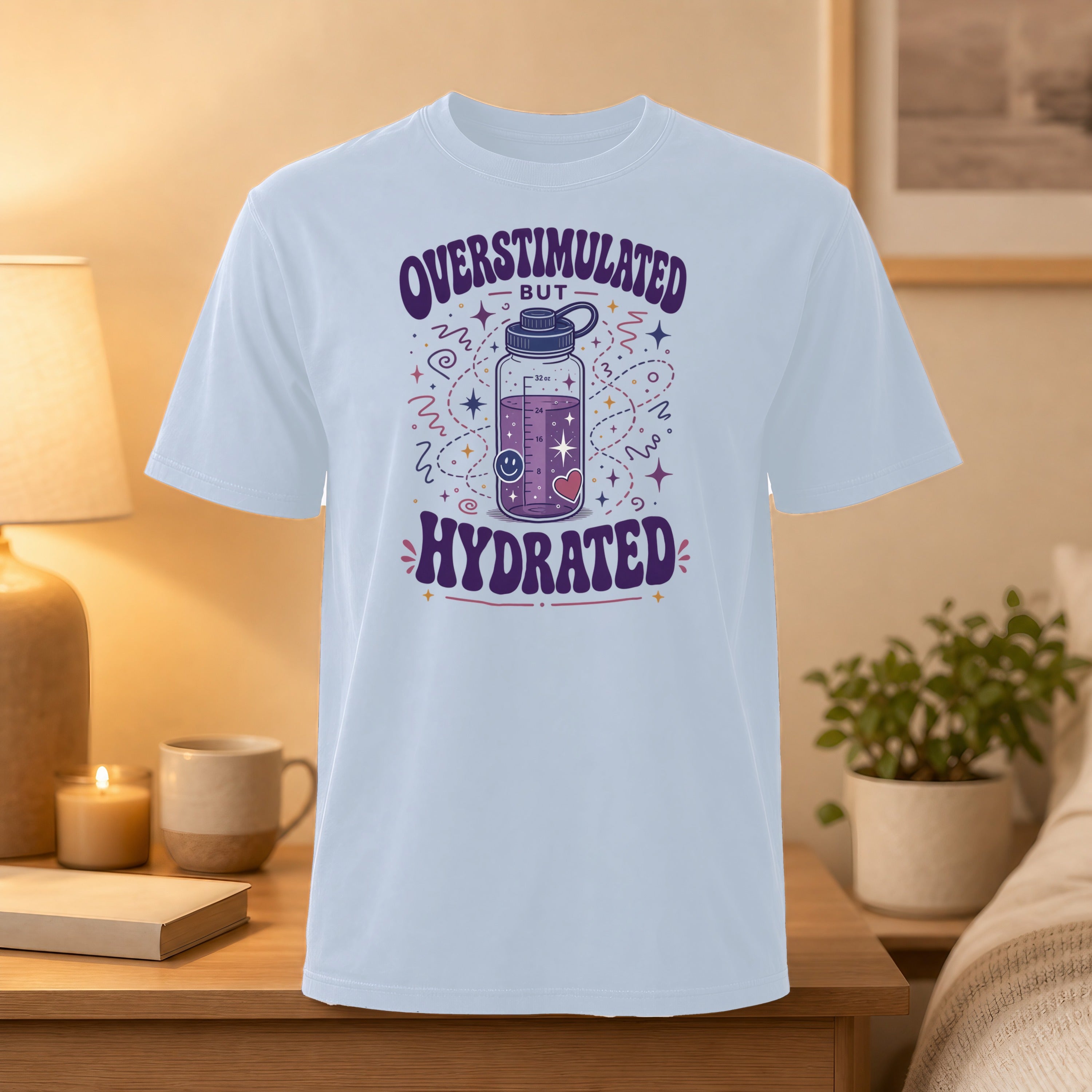 White t-shirt with "Overstimulated but Hydrated" text and a water bottle graphic.