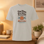 White t-shirt with "I'm Fine. It's Fine. Everything's Fine." and smiling sun graphic.