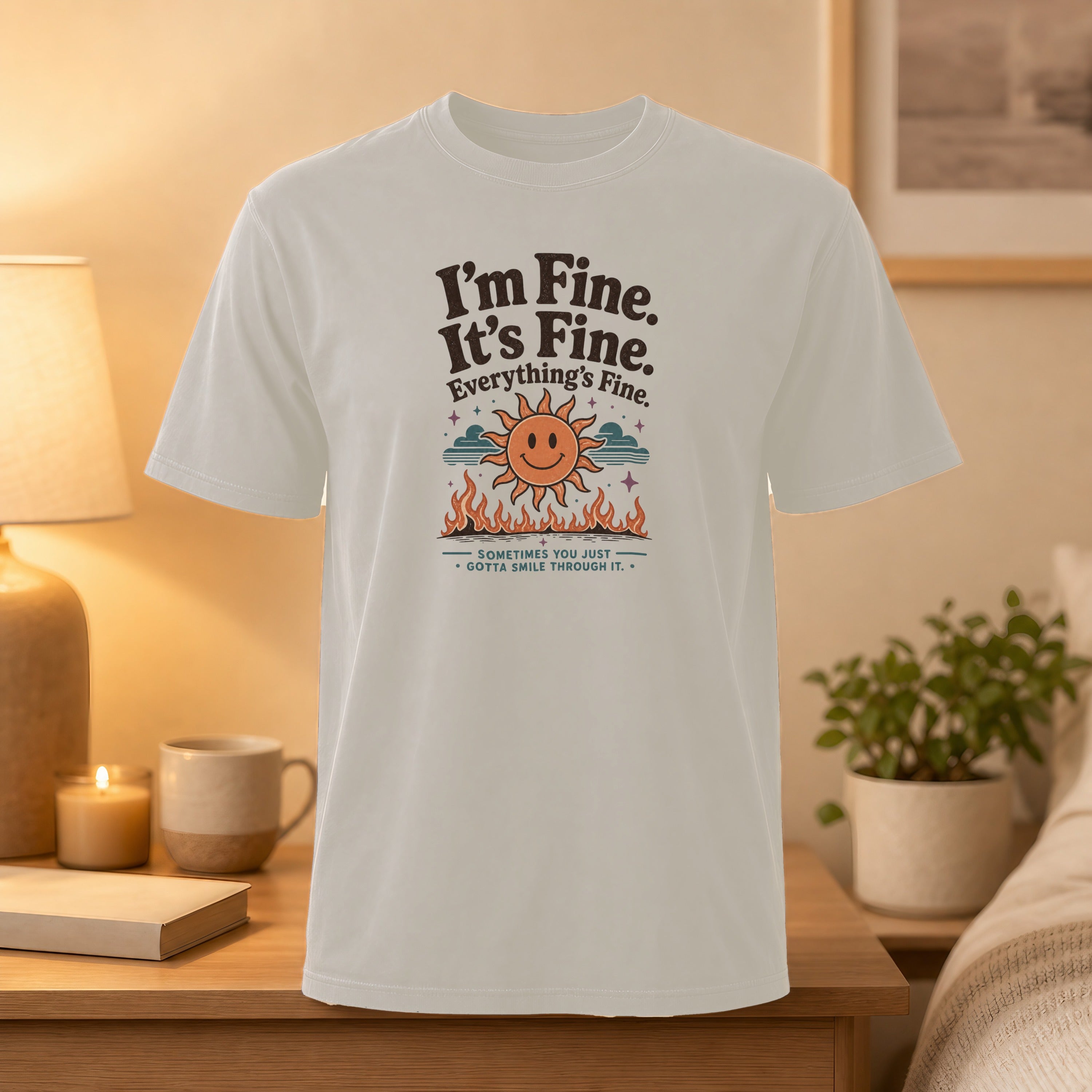 White t-shirt with "I'm Fine. It's Fine. Everything's Fine." and smiling sun graphic.