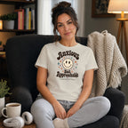 Woman wearing "Anxious But Approachable" graphic tee, sitting in chair.