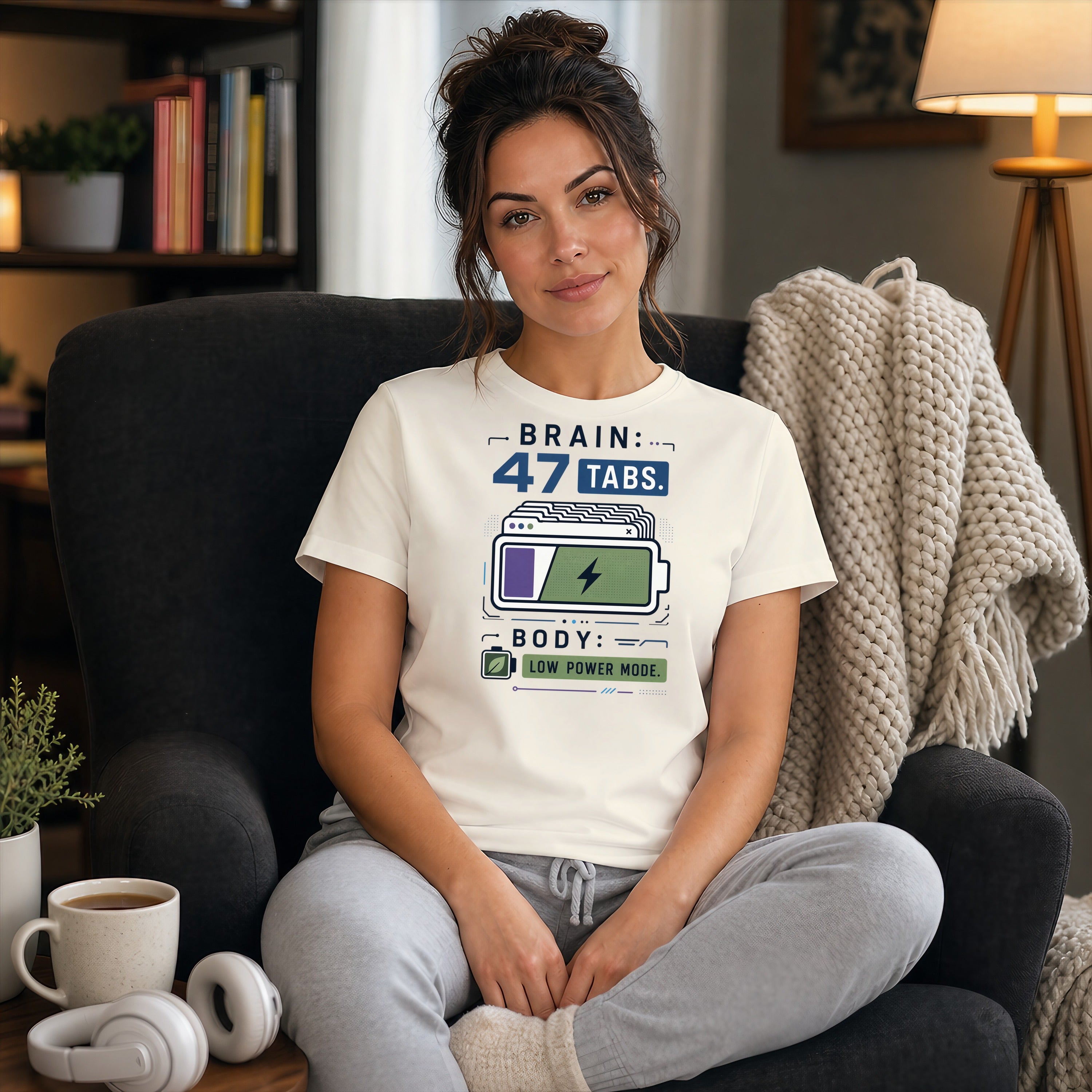 Woman in graphic t-shirt with "BRAIN: 47 TABS. BODY: LOW POWER MODE."