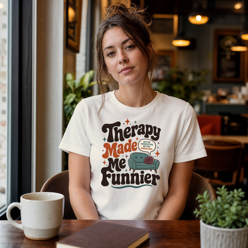 Woman wearing white t-shirt with "Therapy Made Me Funnier" text.