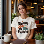 Woman wearing white t-shirt with "Therapy Made Me Funnier" text.