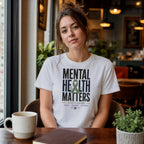 Woman in white t-shirt with "Mental Health Matters" text and green ribbon.