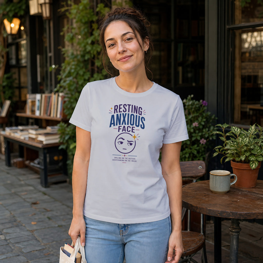 Woman wearing white t-shirt with "Resting Anxious Face" graphic.