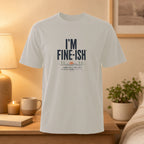 Light grey t-shirt with "I'M FINE-ISH" and creative sun/tree graphic.