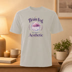 Light gray t-shirt with "Brain Fog But Make It Aesthetic" text and cloud design.