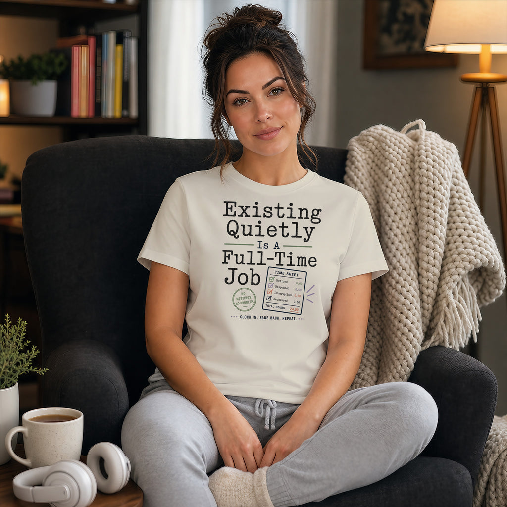 Woman wearing a t-shirt that says "Existing Quietly Is A Full-Time Job" with a time sheet.