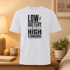 White t-shirt with "Low Battery, High Standards" text and lightning bolt graphic.