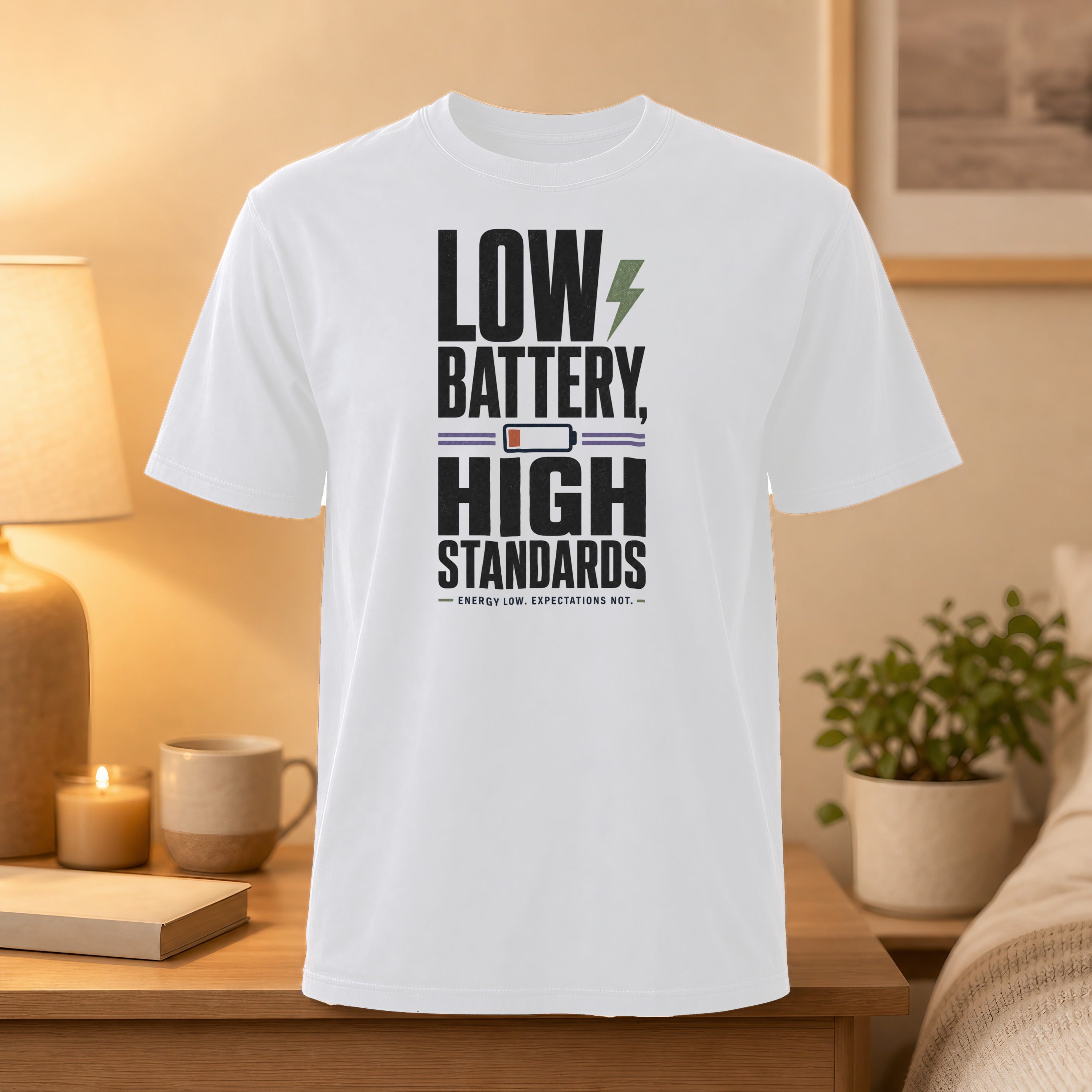 White t-shirt with "Low Battery, High Standards" text and lightning bolt graphic.