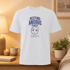 White t-shirt with "Resting Anxious Face" text and emoji graphic.
