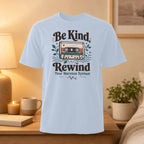 Light blue t-shirt with "Be Kind Rewind Your Nervous System" and cassette tape graphic.