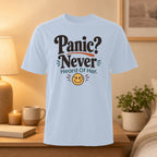 Light blue t-shirt with "Panic? Never Heard Of Her." and a smiling emoji.