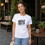 Woman wearing a white t-shirt with text "Mentally Here-ish"