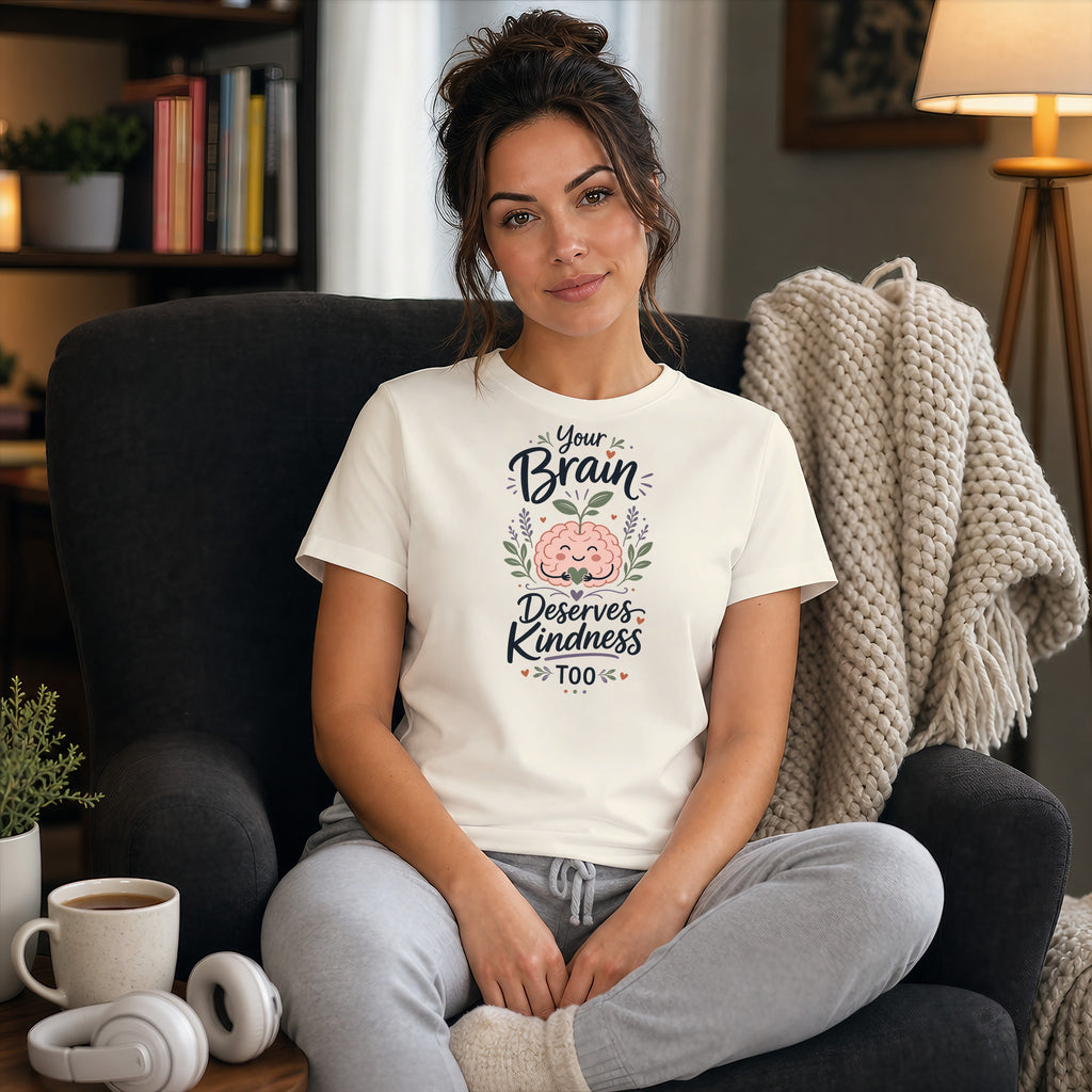 Woman in a cream t-shirt with "Your Brain Deserves Kindness Too" text design.