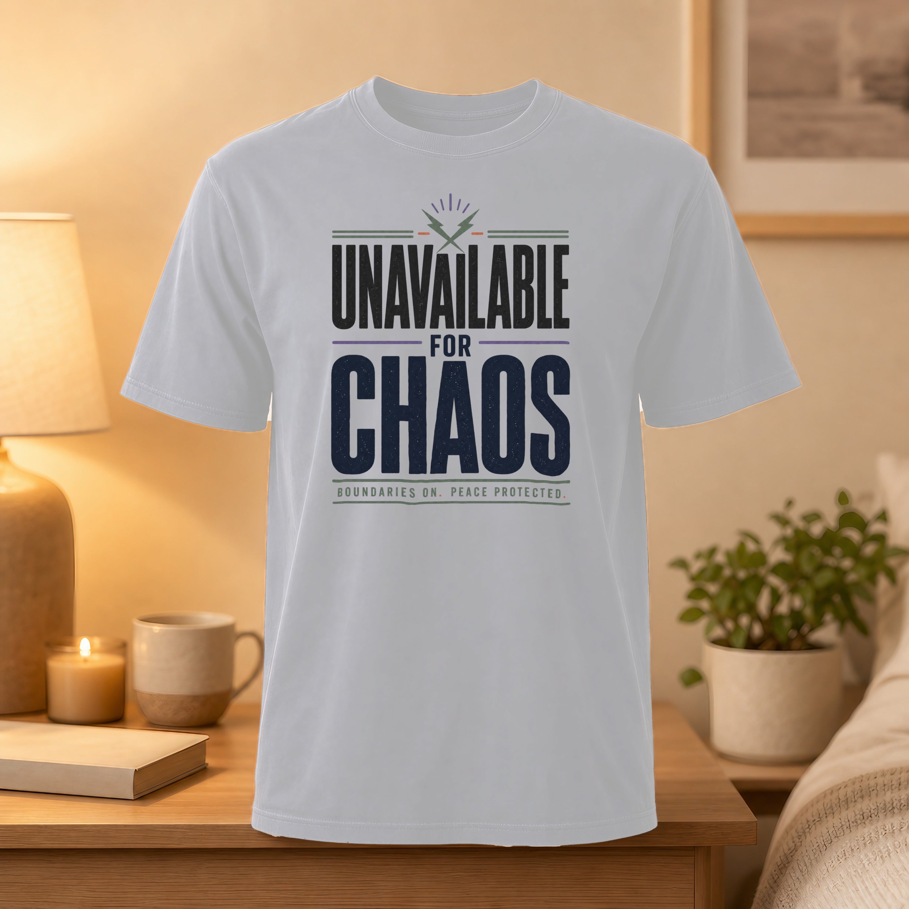 White t-shirt with "Unavailable for Chaos" text in purple and black.
