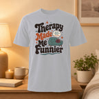 White t-shirt with "Therapy Made Me Funnier" text and sofa icon.