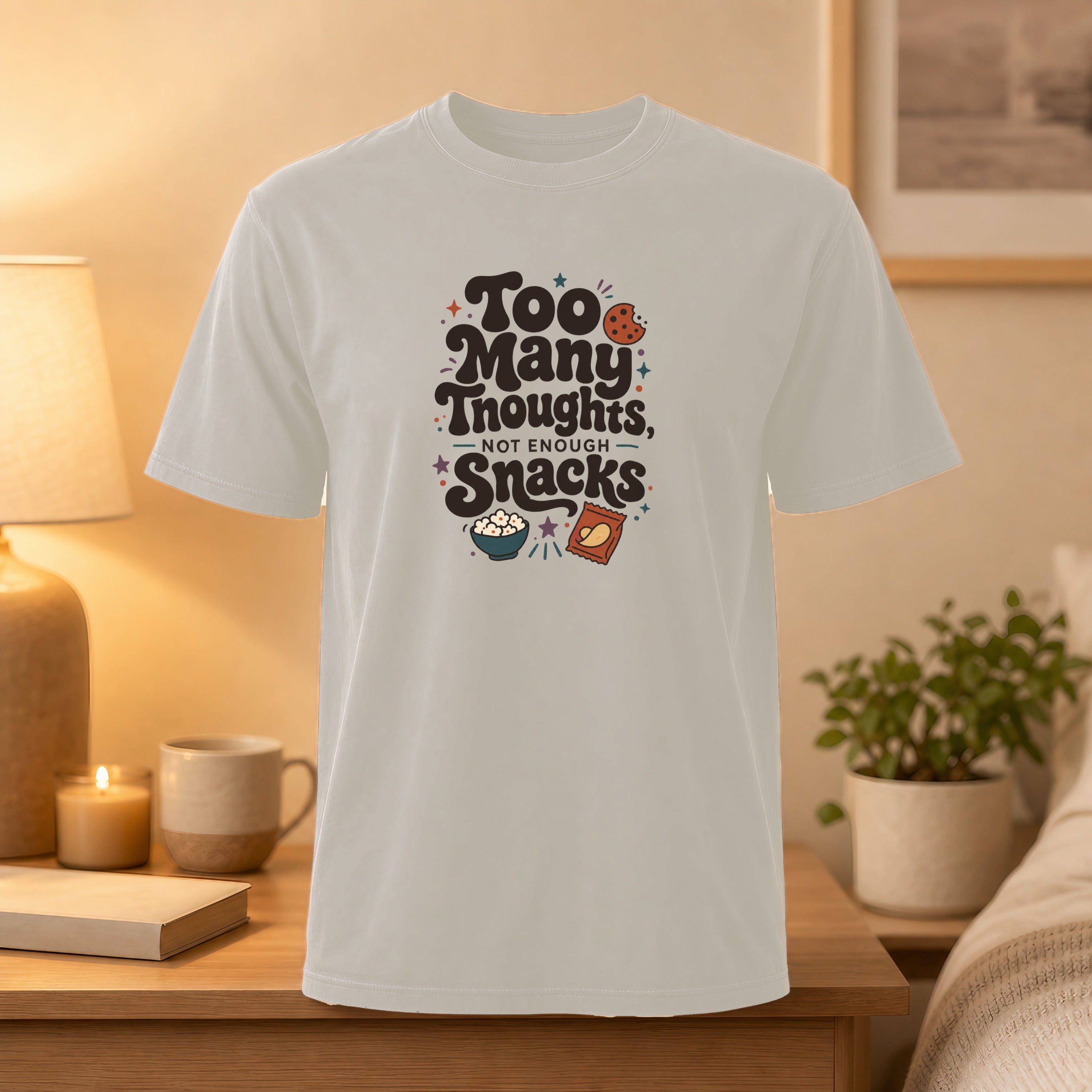 Light gray t-shirt with "Too Many Thoughts, Not Enough Snacks" text and snack graphics.