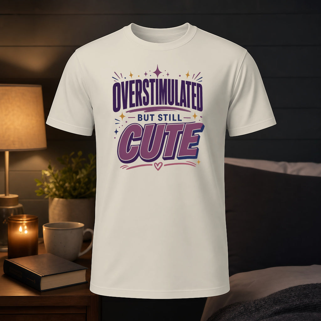 White t-shirt with "OVERSTIMULATED BUT STILL CUTE" text.