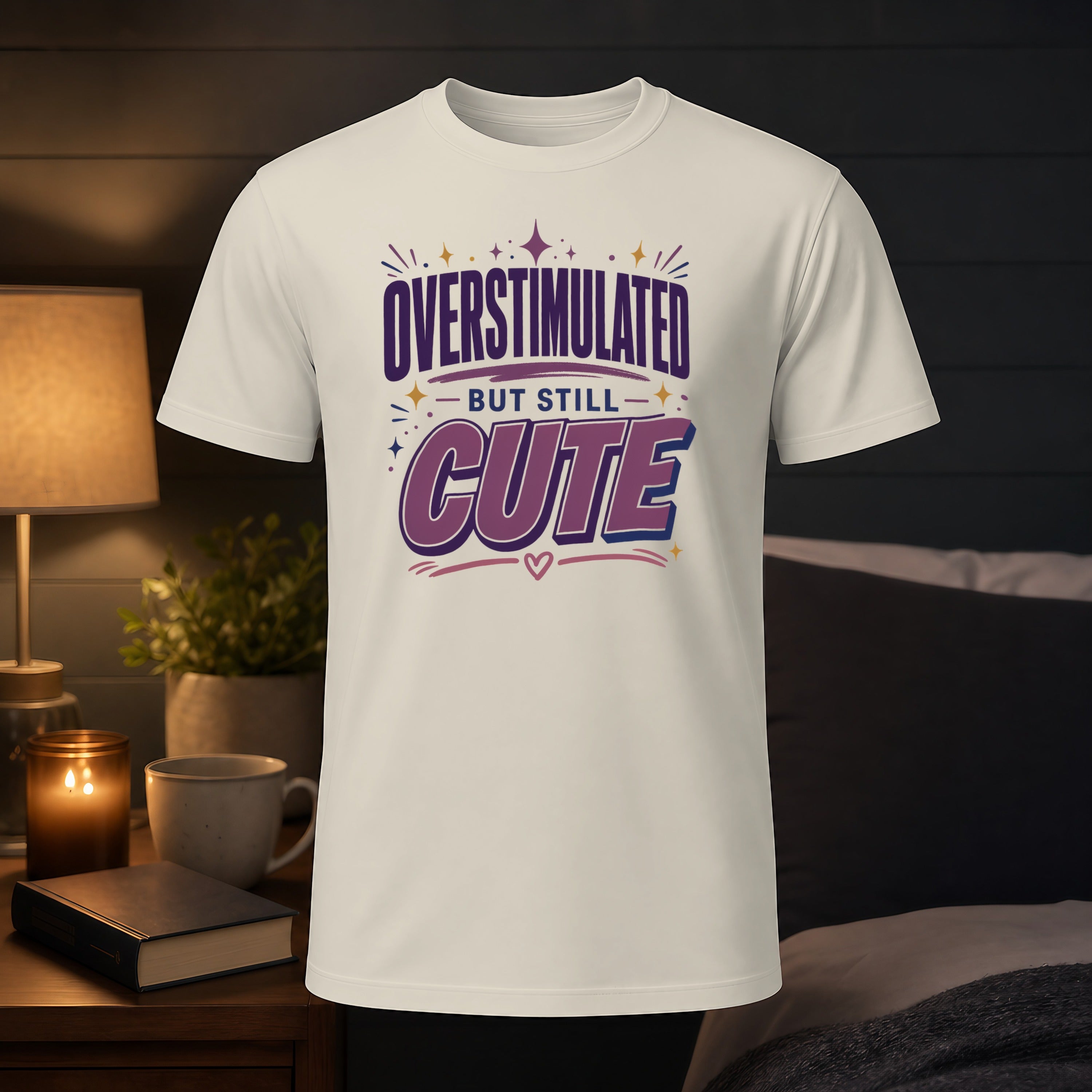 White t-shirt with "OVERSTIMULATED BUT STILL CUTE" text.
