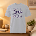 White t-shirt with "Anxiety with a Nice Font" and doodles about anxiety.