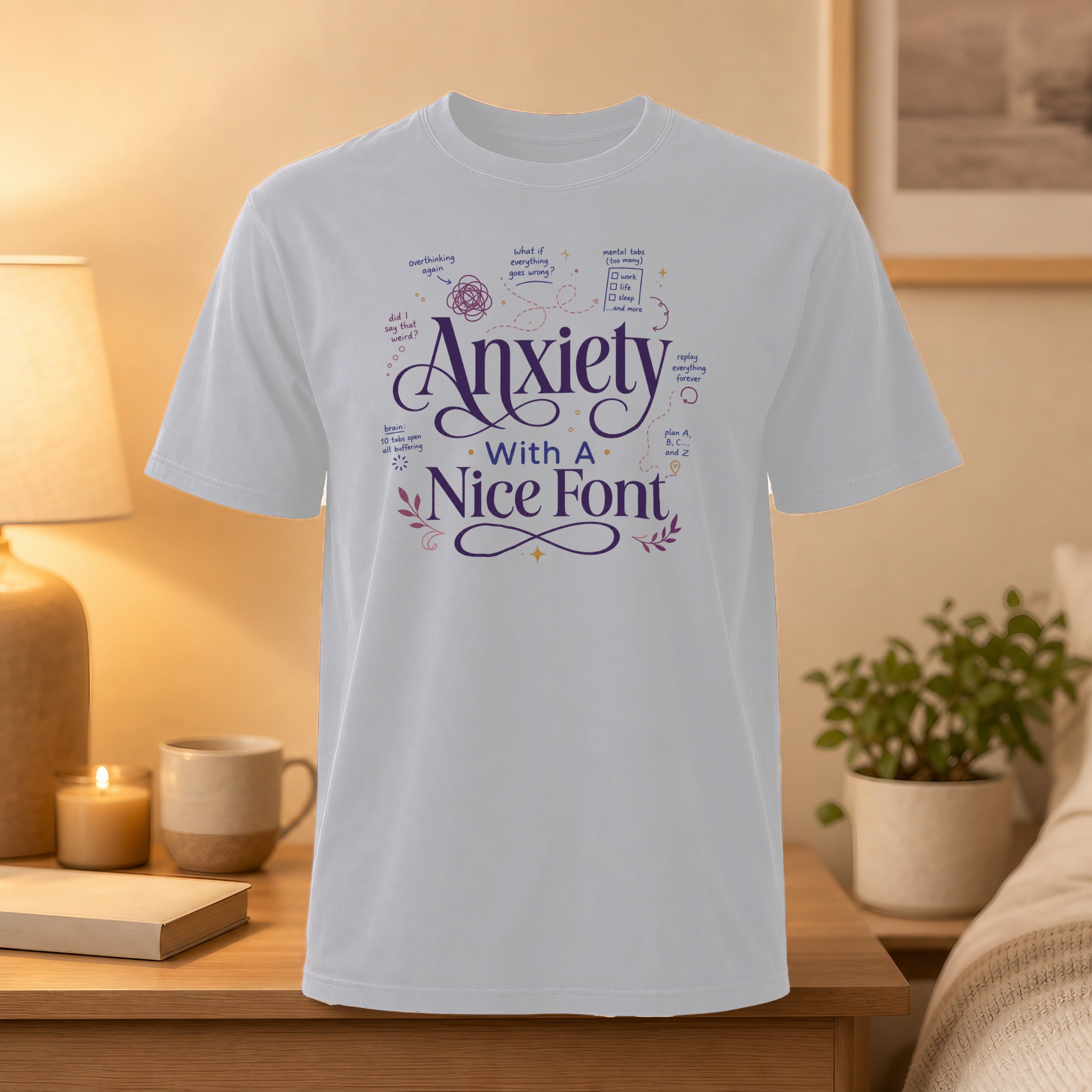 White t-shirt with "Anxiety with a Nice Font" and doodles about anxiety.