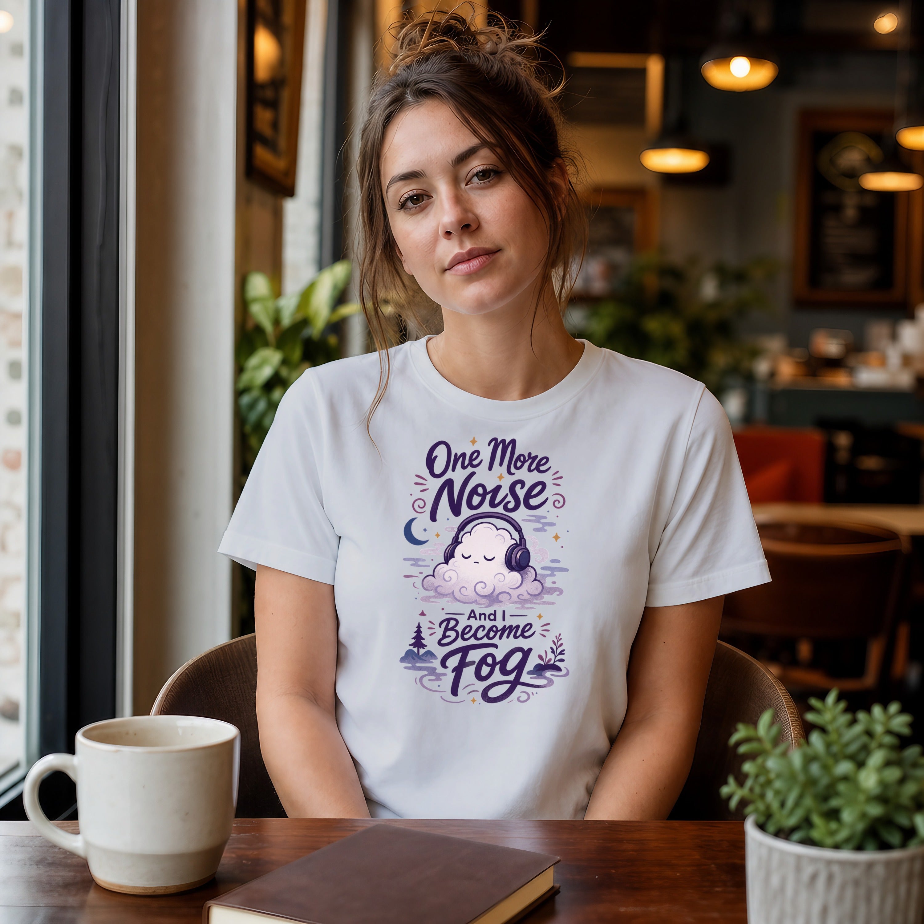 Woman in white t-shirt with "One More Noise and I Become Fog" graphic.