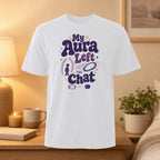 White t-shirt with "My Aura Left The Chat" text and mystical graphics.
