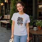 Woman wearing white t-shirt with "Too Many Thoughts, Not Enough Snacks" text and snack graphics.