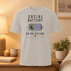 White t-shirt with "Social Battery: Charging In Progress" and moon icon.