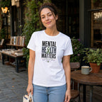 Woman wearing a white t-shirt with "Mental Health Matters" and awareness ribbon graphic.