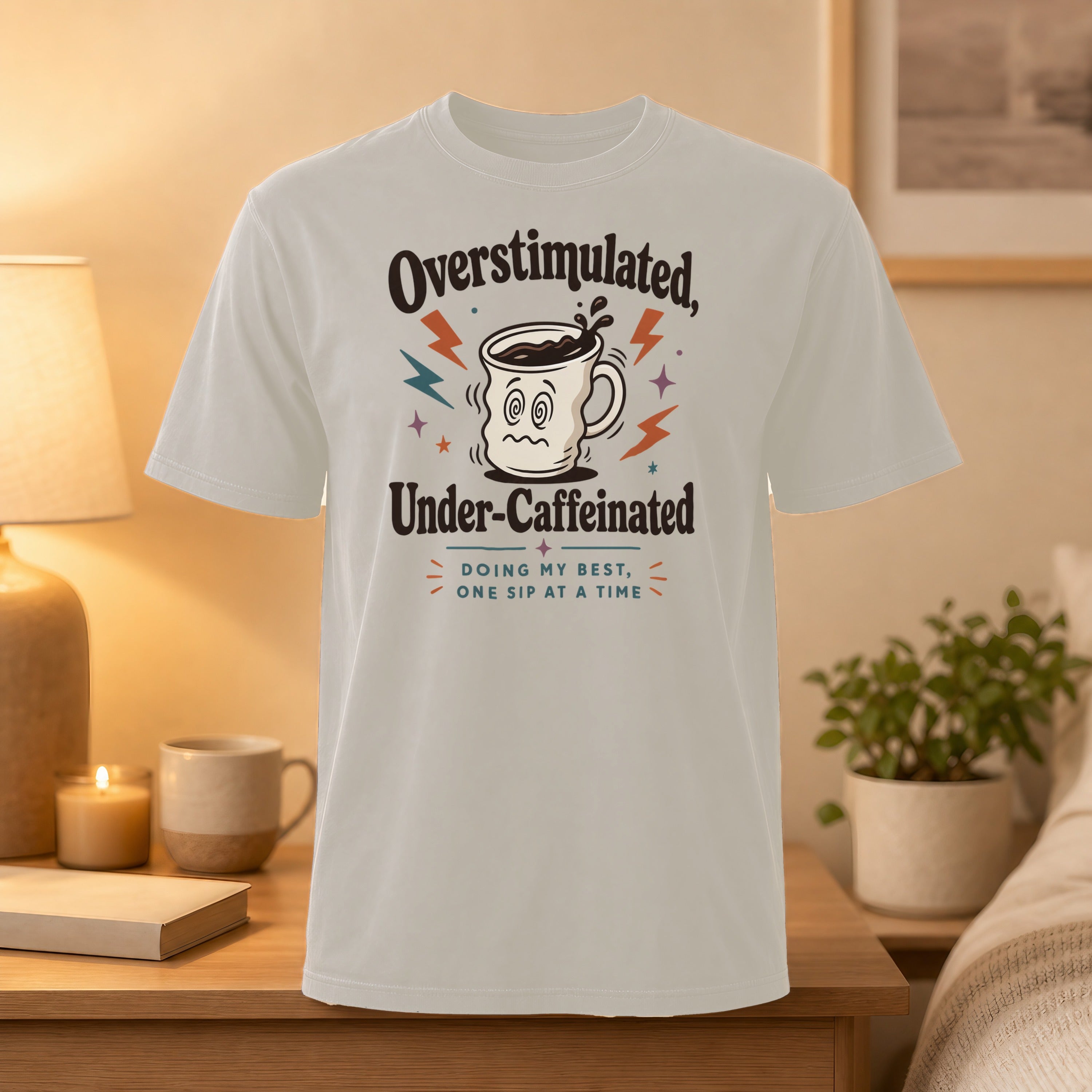 T-shirt with "Overstimulated, Under-Caffeinated" and coffee cup graphic.