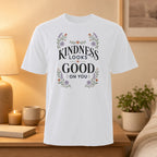 White t-shirt with "Kindness Looks Good On You" text and floral design.