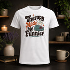 White t-shirt with "Therapy Made Me Funnier" text and a sofa graphic.