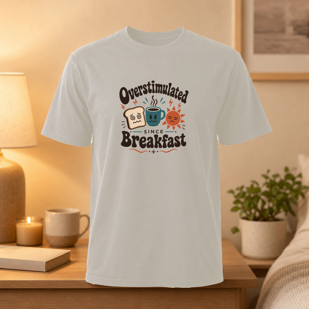 T-shirt with "Overstimulated Since Breakfast" text and breakfast-themed emojis.