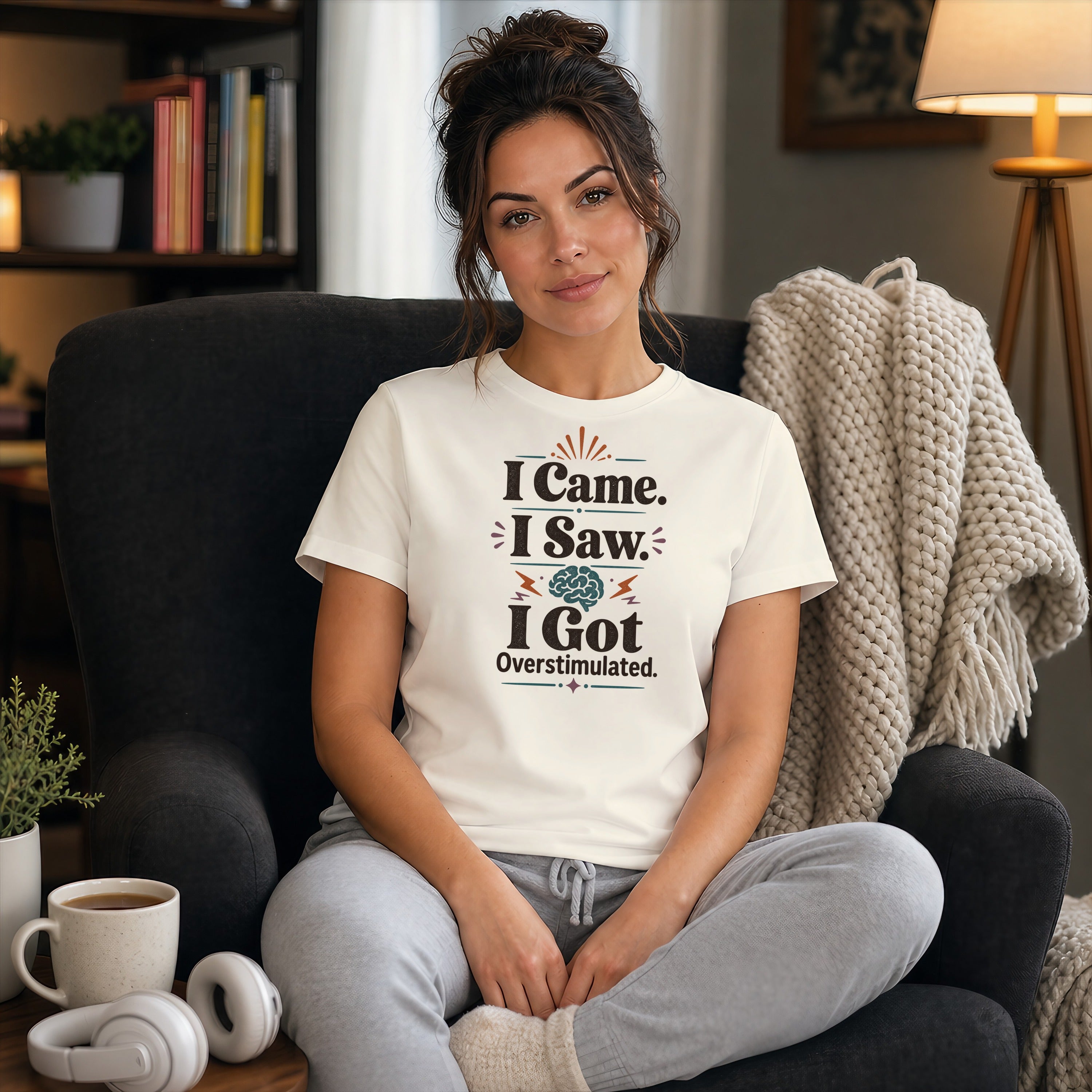 Woman in armchair wearing t-shirt that says "I Came. I Saw. I Got Overstimulated."