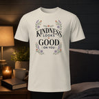 T-shirt with "Kindness looks good on you" floral text design.