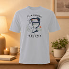 White t-shirt with illustration of a woman's head, text "Calm outside, tabs open inside."