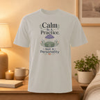 White t-shirt with "Calm is a Practice, Not a Personality" text and lotus flower graphic.