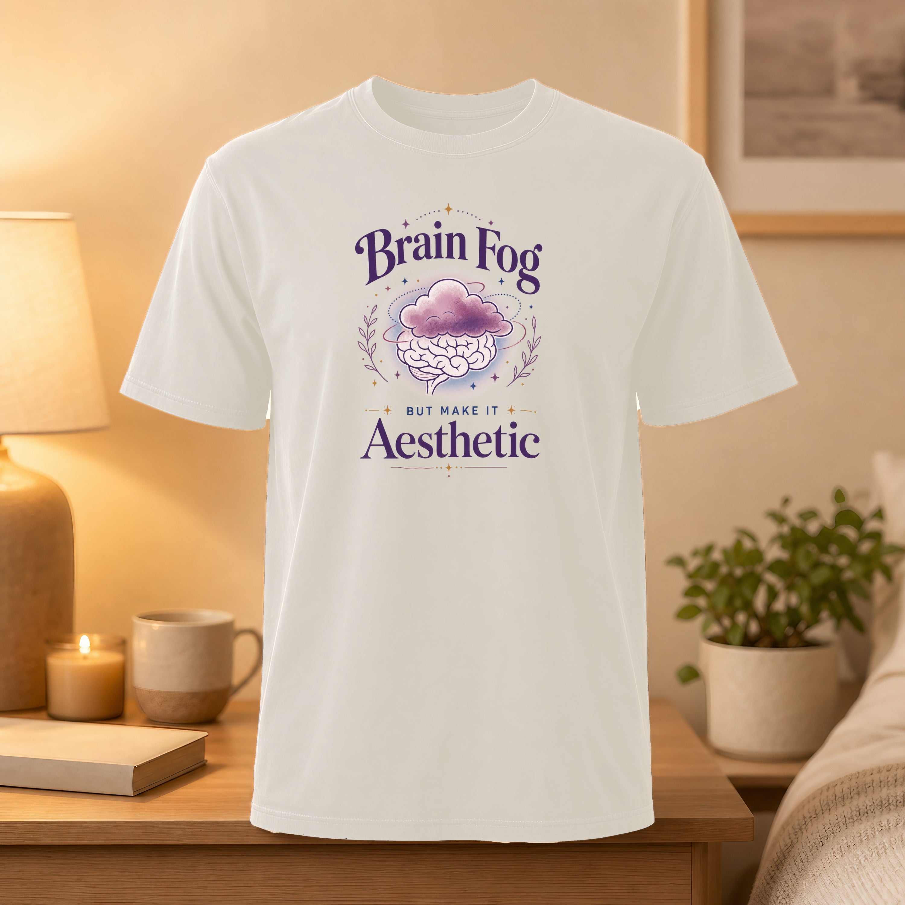 White t-shirt with "Brain Fog But Make It Aesthetic" text and cloud illustration.